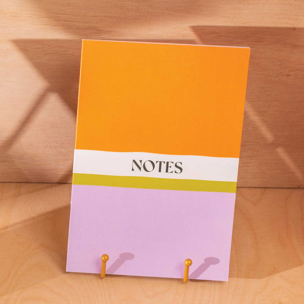 A5, 60 Page, Lined Notebook with a Orange and Purple Colour Block cover.