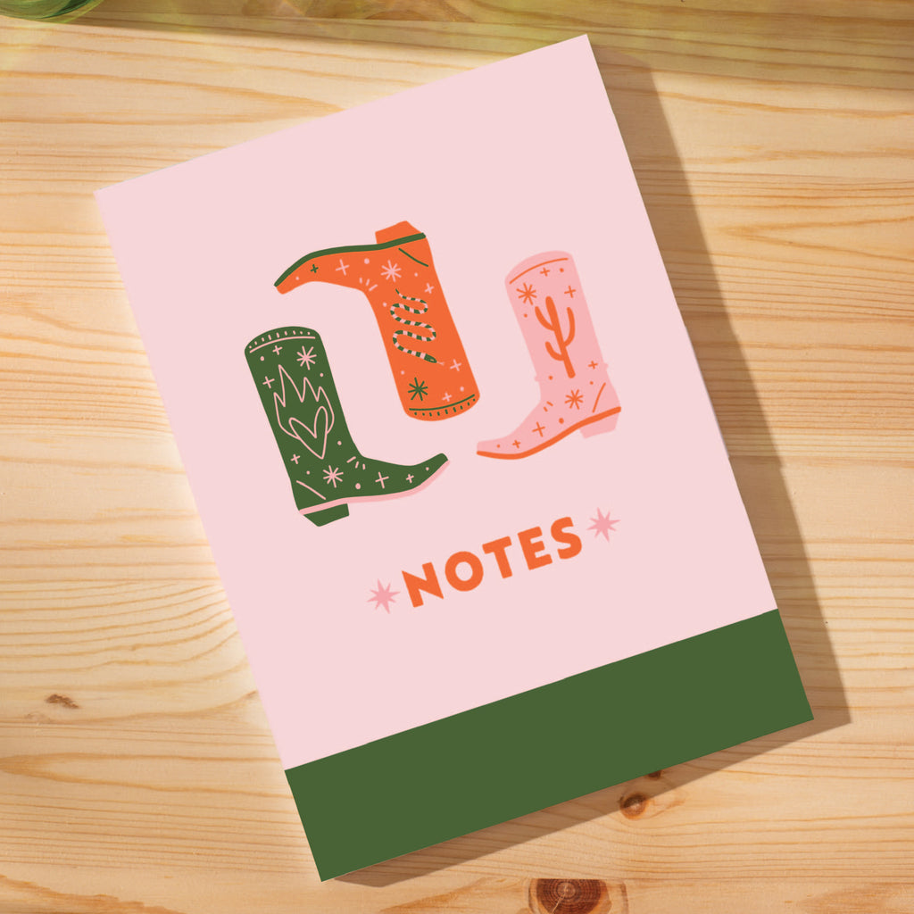 a5 notebook. 60 pages. 100% recycled paper. made in the UK. Cowboy boots, western boho inspired. Red, green, pink.