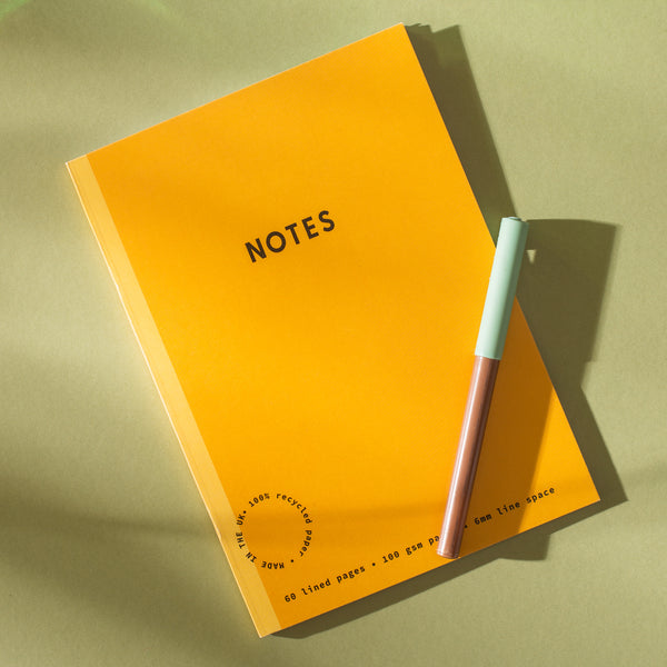 set of 2 A5 lined notebooks in yellow and mint. 100% recycled paper.